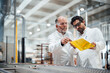 © Westend61 - Engineers discussing product development in a factory setting
