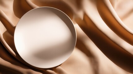 Poster - Minimalistic plate on soft fabric, showcasing elegance and simplicity in a serene setting