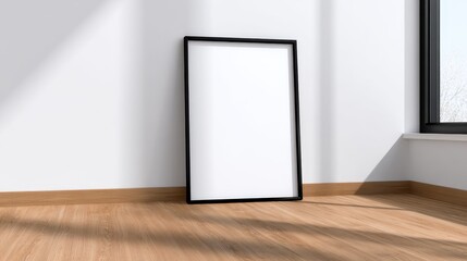 Poster - Empty black frame leaning against a wall in a sunlit room with wooden flooring