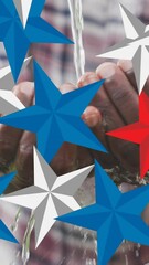 Poster - Animation of red, blue and white stars over african american male washing hands