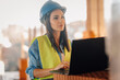© Ljustina - Female architect working on laptop at construction site