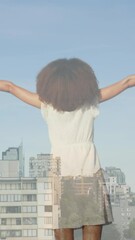 Poster - Animation of cityscape over african american woman with arms outstretched