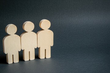 Poster - Three simple wooden figures stand in a row against a dark background