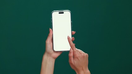Poster - User, hands or phone screen with mockup space in studio for advertising or UX on a green background. Person, model or display with mobile smartphone for new app, social media platform or UI marketing