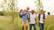 © Monkey Business - Group Of Mature Male Friends Walking Along Path Through Yurt Campsite