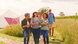 © Monkey Business - Portrait Of Group Of Smiling Mature Friends Walking Through Countryside Against Flaring Sun