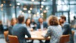 © David Zarzosa - Blurred image of business meeting in modern office, professional team discussion around conference table in corporate environment.