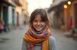 © Vadym - Happy multiracial young girl wearing colorful scarf smiling at camera. Portrait of cute kid with mixed race smiling outdoor at city street. Child with scarf, casual style, good mood.