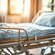 © Latevanila - A hospital bed with a blue sheet and pillow is visible