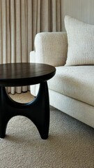 Poster - A beautifully arranged living area featuring a sleek couch, elegant side table, and soft textures, creating a welcoming atmosphere