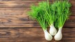 © Rinowz - Close-up of fresh fennel bulbs with green feathery fronds, placed on a rustic wooden surface, soft natural lighting, clean and aromatic atmosphere