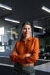 © Stock 4 You - Vertical portrait of successful hispanic young business woman, saleswoman manager smiling at camera. Confident latin executive female leader professional businesswoman standing crossed arms in office