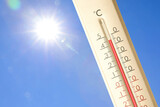 Extremely high temperature on thermometer against blue sky on sunny day. Summer weather Extremely high temperature on thermometer against blue sky on sunny day. Summer weather
