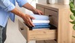 © Sri - Man Folding Clothes Into Drawer