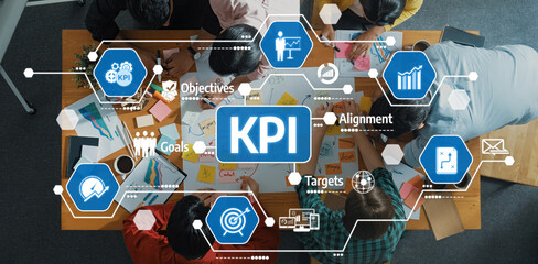 Poster - Team members are actively engaged in a meeting analyzing key performance indicators using visual charts and diagrams, fostering collaboration and strategic planning in a modern office. Amity