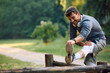 © Drazen - Happy sportsman doing stretching exercises while working out in park.