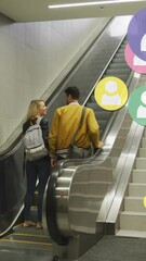 Poster - Animation of social media icons floating over happy caucasian couple holding hands on escalators