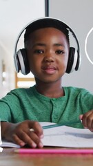 Aufkleber - Animation of school icons over smiling african american schoolboy having video call