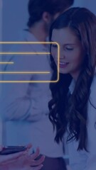 Poster - Animation of orange online chat icon over caucasian businesswomen with smartphone at casual office