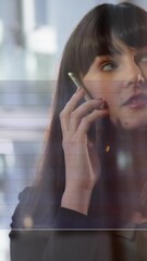 Poster - Animation of financial data processing over caucasian businesswoman talking on smartphone