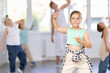© JackF - In sports studio, creative childrens team learns hip-hop dance accompanied by experienced man teacher