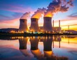 © Masrur - Nuclear facilities at dusk, smokestacks glowing under dramatic skies, reflections in cooling pools of water
