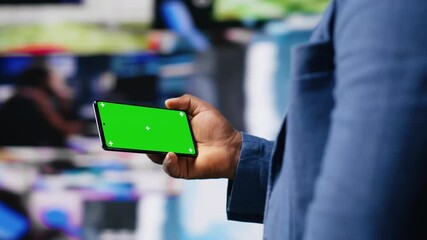 Poster - African american user holding a phone with isolated mockup display, digital system of networks and apps on dashboard. Highlighting the integration of AI and fintech. Multitasking. Camera B.