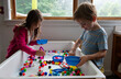 © Cara Dolan/Stocksy - Two young children play together at a sensory table