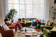 © BONNINSTUDIO/Stocksy - Group of students studying and eating pizza in messy living room