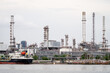 A shipping boat docked at a power plant and a shipping port in Bangkok
