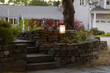 © Raymond Forbes LLC/Stocksy - Landscape Architecture stone wall lighting dusk