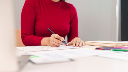 Canvas Print - ui ux designer at work asian adult woman drawing wireframes for mobile app on desk with pencil and s