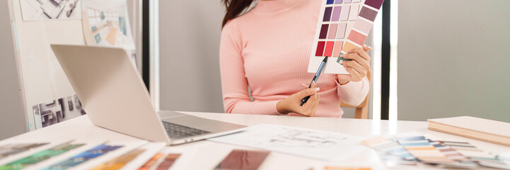 Wall Mural - Asian Adult Woman UI UX Designer Working with Color Palette on Laptop for Website App Interface Design Inspiration and Creative Project Ideas