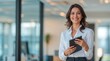 © VistaVisions - Portrait of smiling mature business woman executive, happy businesswoman entrepreneur, company hr holding digital tablet looking at camera standing in office at work