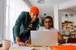 © BONNINSTUDIO/Stocksy - Two happy roommates studying together on apartment
