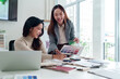 © Pichsakul - Asian Interior Designers Discussing Color Palette Samples for Home Renovation Project in Modern Office Space with Laptop for Presentation Ideas