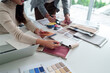 © Pichsakul - Asian woman interior designer team working with fabric sample, color palette for home renovation project. Architect choosing material for building design. Collaboration on modern decor ideas