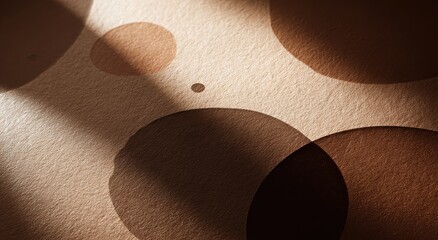 Aufkleber - Textured beige background with varying sizes of brown circles, dramatically lit by a diagonal spotlight