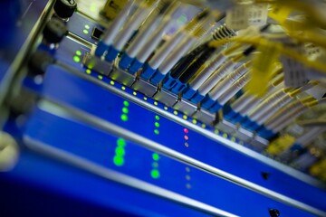 Poster - Rack-mounted fiber-optic patch panel is showing in flat-style with blue yellow cables, glowing LEDs