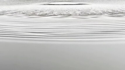 Poster - Concentric water ripples create a calming abstract pattern on a smooth, gray surface