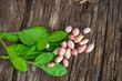 © Kiran - Peanuts in a peel in a wooden bowl. peeled peanut on peanut group on wooden bowl.