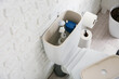 © Pixel-Shot - Toilet bowl with removed tank lid and water in light restroom