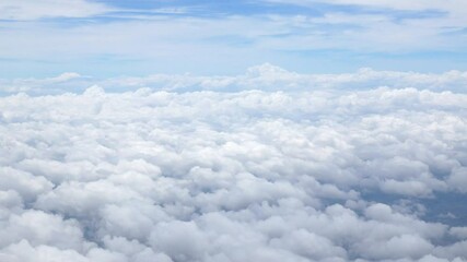 Wall Mural - blue sky with white fluffy clouds from airplane flight fly over the clouds in a sunny day with cloud moving in the atmosphere in hot weather summer time.