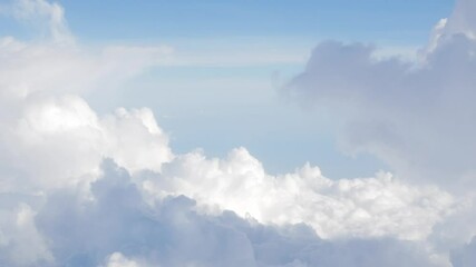 Wall Mural - blue sky with white fluffy clouds from airplane flight fly over the clouds in a sunny day with cloud moving in summer