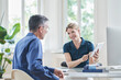 © Westend61 - Smiling doctor discussing over tablet PC with patient at medical practice