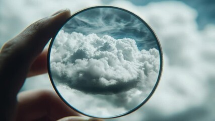 Aufkleber - A person holds a magnifying lens in front of a cloudy sky, perfect for detective or science-themed illustrations