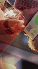 Poster - Animation of man holding smartphone with covid 19 vaccination passport over man drinking beer