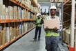 © Serhii - Portrait of a handsome african american warehouse worker in overalls and a helmet