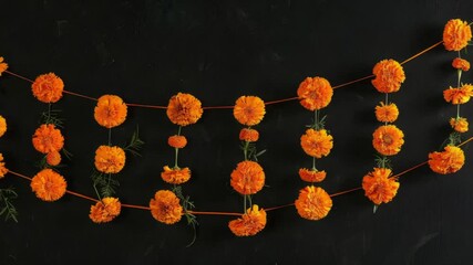 Poster - A bunch of orange flowers suspended from a string, perfect for decorating or adding a pop of color to any setting
