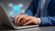 © sbgraphic - Businessman typing on a laptop with glowing email icons symbolizing digital communication and correspondence